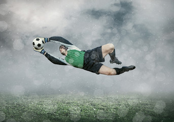 Football player with ball in action under sky with clouds