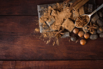 Chocolate, Spices, Spoon with Cocoa on the Wooden Background. Copy space. Flat lay, top view