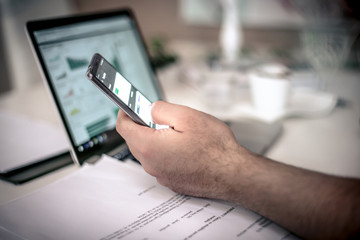 Focus businessman hand using mobile phone.