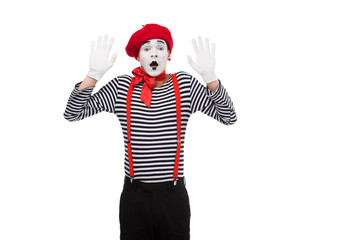 shocked mime standing with hands up isolated on white