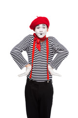 surprised mime standing with hands akimbo isolated on white