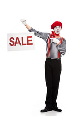 happy mime pointing on sale signboard isolated on white