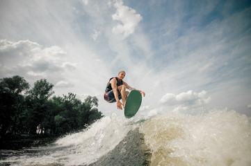 wakeboarder performs various tricks in a jump