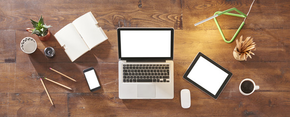 technological tools banner like laptop tablet and smartphone. Green lamp concept with pencil and notebook.