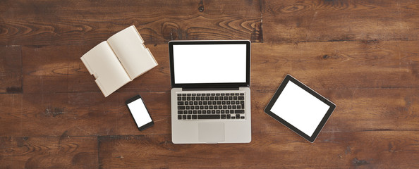 technological tools banner, laptop tablet and smartphone with notebook on the wood old table office...