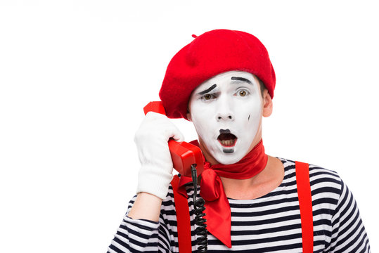 shocked mime talking by stationary telephone isolated on white