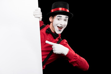 mime pointing on empty board isolated on black