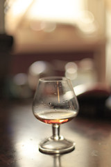 Glass of cognac almost empty