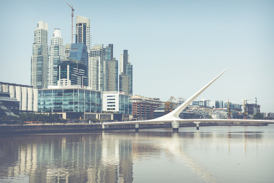 Puerto Madero Waterfront district. Modern skyline at sunny day. View of Puente de la Mujer .