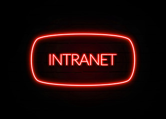 Intranet neon sign on brick wall background.