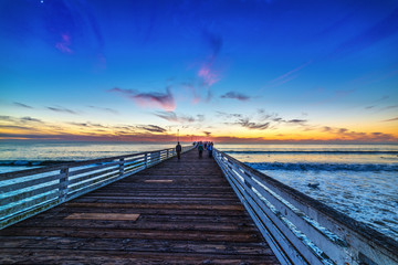 Fototapeta na wymiar People in Pacific Beach pier at sunset