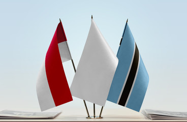 Flags of Monaco and Botswana with a white flag in the middle