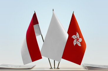 Flags of Monaco and Hong Kong with a white flag in the middle
