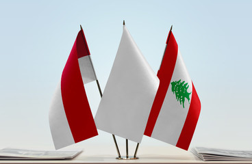 Flags of Monaco and Lebanon with a white flag in the middle