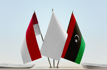 Flags of Monaco and Libya with a white flag in the middle