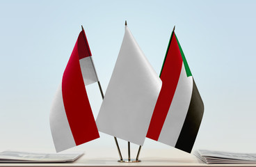 Flags of Monaco and Sudan with a white flag in the middle