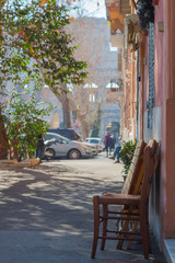 Street scene - wooden chair with Coliseum background, shallow focus, saturated treatment. Rome, Italy.