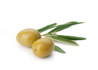 Two green olives with leaves