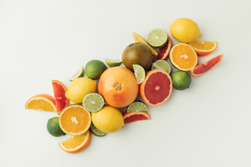 Pile of ripe lemons, limes, oranges and grapefruits  on white background