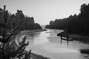 Winter view of Sornoer Canal. Canal connect lakes Geierswalder See and Sedlitzer See. The surroundings of Senftenberg. Germany. Federal state of Brandenburg. Black and white.