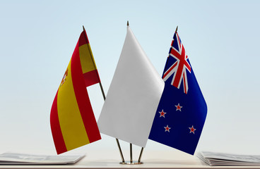 Flags of Spain and New Zealand with a white flag in the middle