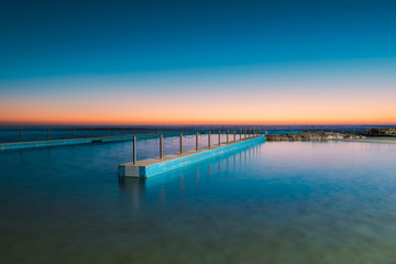 Fototapeta na wymiar Empty swimming pool in the morning dawn.