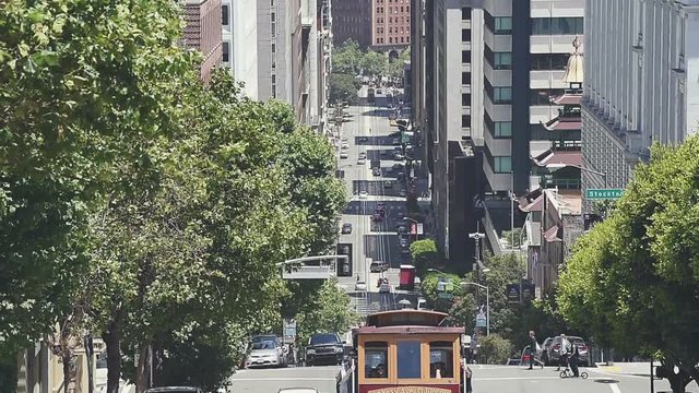 Slow motion view of San Francisco from Nob Hill. Vintage wooden cable car, California Street leading down to the Financial District and Bay Bridge.
