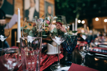 Elegant Wedding table decor with red flowers and red table cloth 