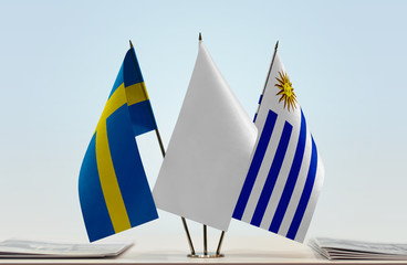 Flags of Sweden and Uruguay with a white flag in the middle