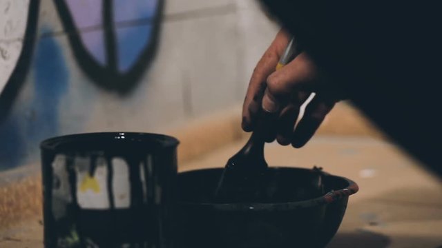 Closeup Shot of Man is Mixing a Black Paint in a Bowl. Shot Taken by Canon 6D.