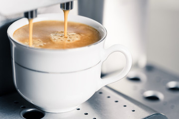 automatic coffee machine making creamy espresso