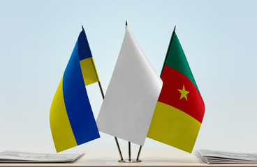 Flags of Ukraine and Cameroon with a white flag in the middle