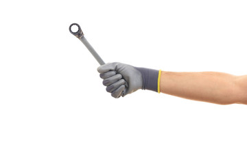 Hand holding a metal spanner on white background