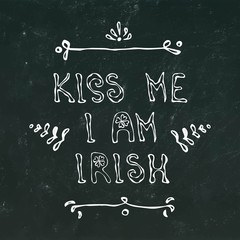 Fototapeta na wymiar Black Chalkboard Background Kiss Me I am Irirsh Lettering. 17 March Celebration St Patricks Irish Day Illustration Hand Drawn. Savoyar Doodle Style.