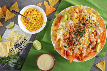 nachos topped a melted creamy cheese sauce