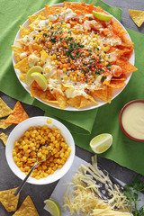 spicy nachos with sauce and corn