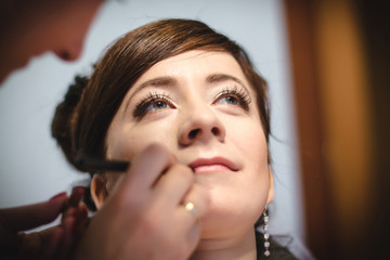 Girl and hands of make-up artist who paint make-up