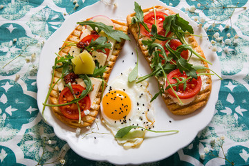 Double toast with egg, aragula, tomato and cheese,French toast bread with veggies,Spring healthy toast, healthy breakfast, italian cuisine

