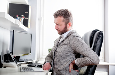 Man in office suffering from back pain