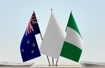 Flags of New Zealand and Nigeria with a white flag in the middle