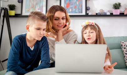 Happy family using together pc laptop at home