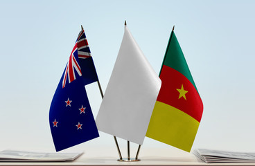 Flags of New Zealand and Cameroon with a white flag in the middle