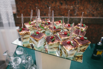 Delicious cookies, marshmallows, macarons and other sweets served on dinner table