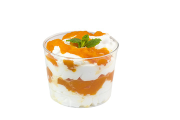 Creamy cream dessert in a plastic cup decorated with berries on a white background. 