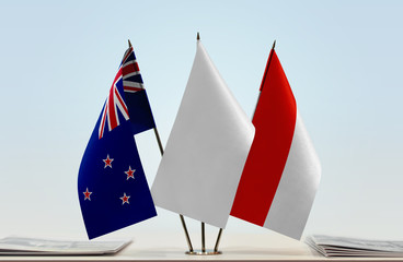 Flags of New Zealand and Indonesia with a white flag in the middle
