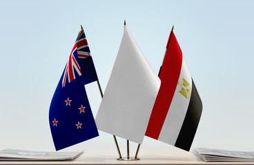 Flags of New Zealand and Egypt with a white flag in the middle