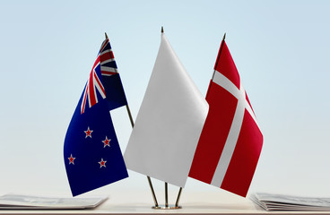 Flags of New Zealand and Denmark with a white flag in the middle