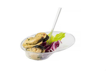 Mini canapes with seafood and vegetables and herbs and in plastic utensils isolated on white background. 