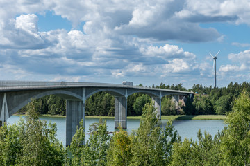 Fototapeta premium Traffic crossing a bridge over water in sunshine
