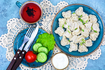 Delicious cooked ravioli on blue plate